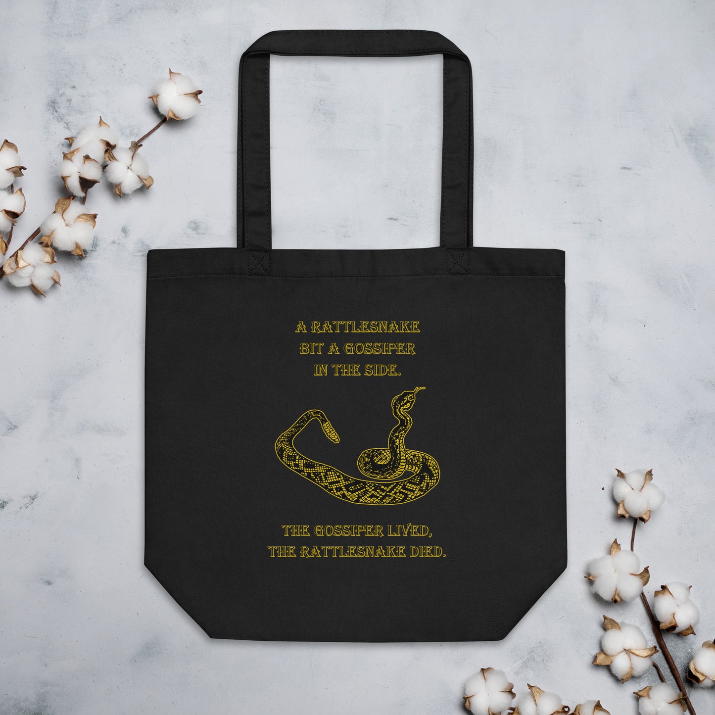 A010 Tote – Eco Tote Bag Featuring a Rattlesnake Graphic and the Text “A Rattlesnake Bit a Gossiper in the Side – The Gossiper Lived, The Rattlesnake Died.”